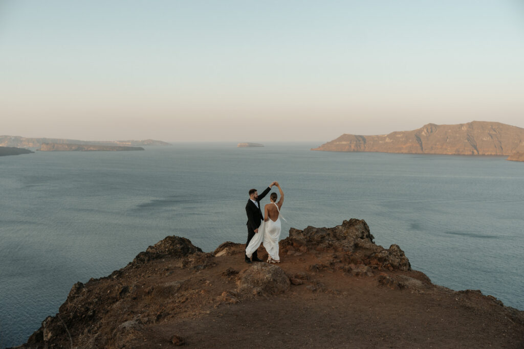 Santorini sunrise elopement on cliffside with caldera views