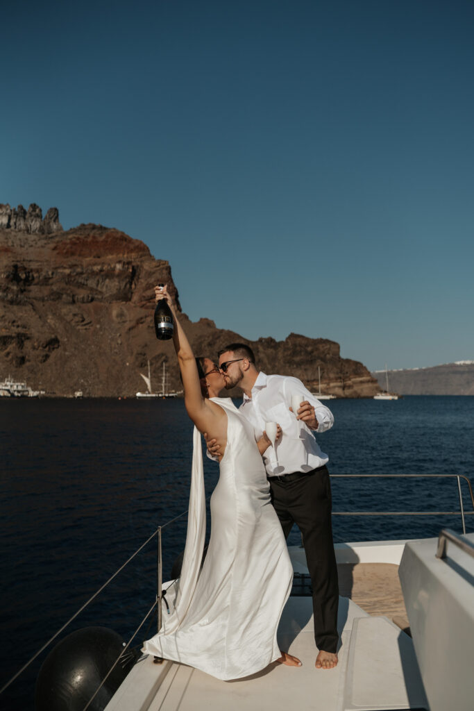 Santorini catamaran elopement sailing across the caldera