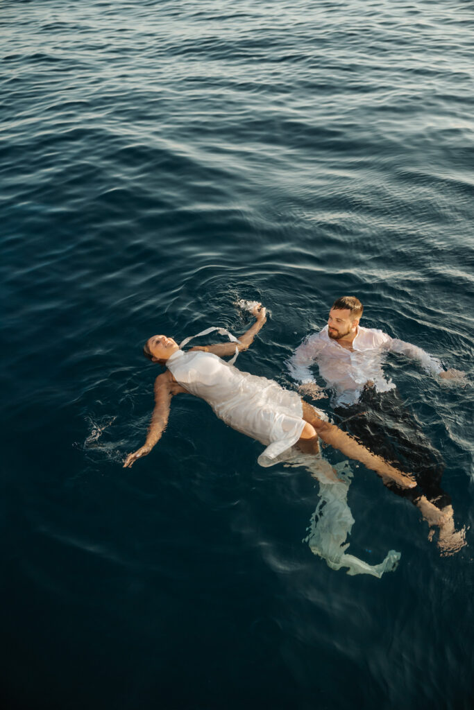 Golden hour couple portrait in catamaran in Santorini